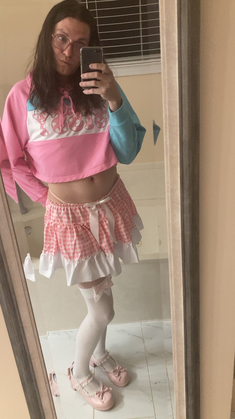Sissy Zoe Simpson — the exposed true self of failed Memphis man Zach Henderson — in a pink gingham ruffle skirt, white thigh-high stockings and pink platform shoes
